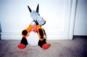 The Penguin cutting one of the scrunchies in two.